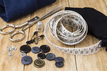 Sewing tools and sewing kit on a wooden background
