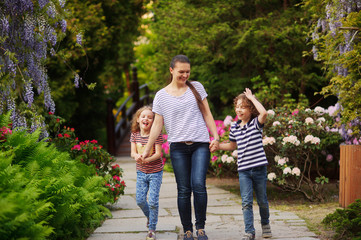 Fototapeta premium Young woman spending time with children in nature