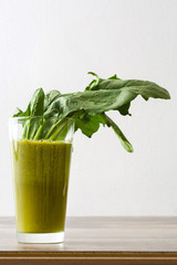 Healthy green detox with spinach, cucumber, lime and apples on a rustic wooden table
