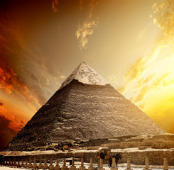 Fototapeta na wymiar Fiery sunset and pyramid