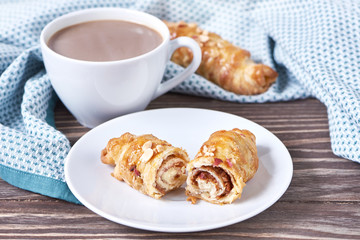Coffee with milk and croissant
