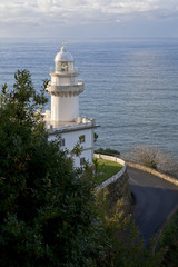 Fototapeta na wymiar San Sebastian. Lighthouse on beside the road to Monte Igueldo. Faro del Monte Igueldo. 