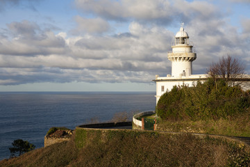 Fototapeta na wymiar San Sebastian. Lighthouse on beside the road to Monte Igueldo. Faro del Monte Igueldo. 