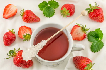 Fresh strawberries with strawberry juice on white fabric