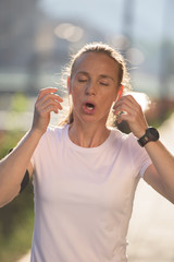 jogging woman setting phone before jogging