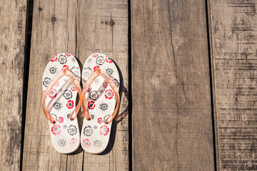 Flip flop on wooden background.