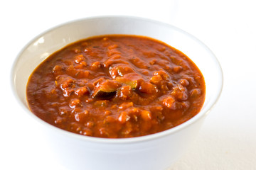spaghetti sauce in a white bowl on white background 