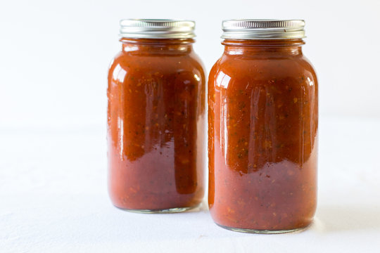 spaghetti sauce in a jar on a white background 