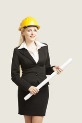 Young female architect/construction engineer  isolated on white