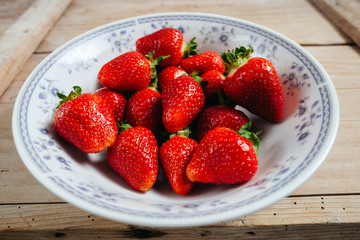strawberry on plate wood background