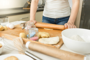 Obraz na płótnie Canvas Closeup of woman making dough in kitchen