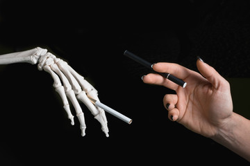 Smoking issues. Conceptual photo with real cigarette against electronic cigarette. 