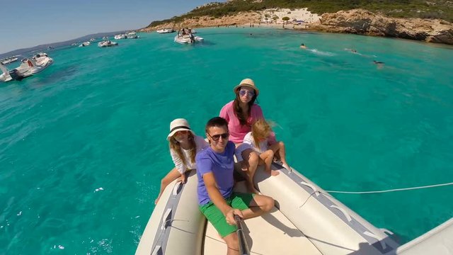 Young Happy Family With Two Little Girls On A Big Boat During Sammer Vacation In Italy