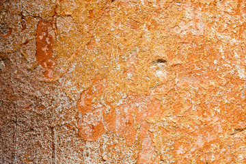 Concrete surface with the remains of orange paint and whitewash © rootstocks
