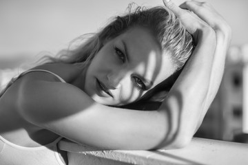 Vacation, beautiful blond woman posing in a swimming pool in the