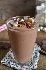 chocolate smoothie with oats and marshmallow on a wooden backgro