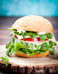 Vegetarian burger with egg, pea patty, fresh salad