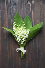 Washable wall murals Lily of the valley lilies of the valley bouquet  on dark wooden background