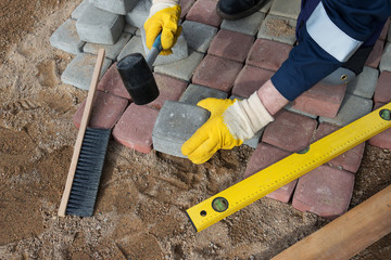 mason worker making sidewalk pavement