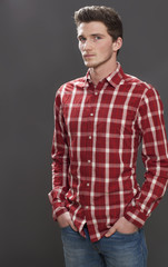 portrait of a intimidated male teenager standing in studio
