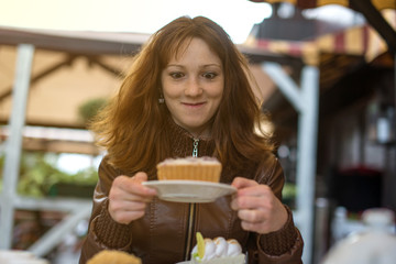 funny girl looking at cupcake