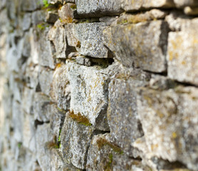 Old stone moss-grown masonry with rich texture