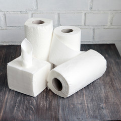 White kitchen paper towel, toilet paper, paper tissue on a dark wooden table