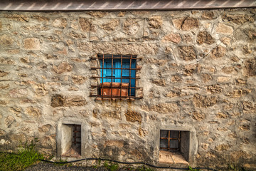 blue window in a rustic wall