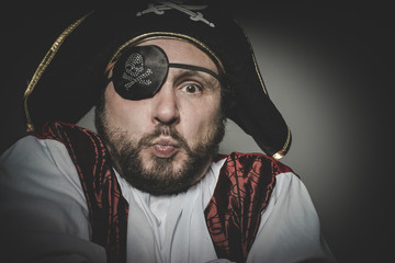 Cute, man pirate with eye patch and old hat with funny faces and