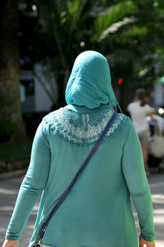 Muslim veiled woman walking down the street