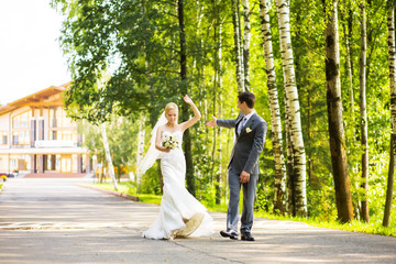 Fototapeta premium Wedding shot of bride and groom in park
