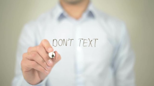 Don't Text And Drive , man writing on transparent screen