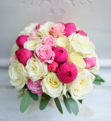 Obraz na płótnie Canvas Beauty of colored flowers. Bridal accessories. Close-up bunch of florets. Details for marriage and for married couple. Wedding bouquet with peonies, roses on the white background
