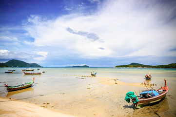 Fototapeta na wymiar Long-tail boats on Rawai beach at low tide, Phuket, Thailand