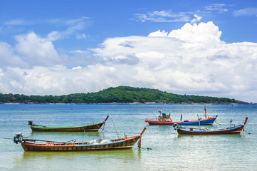 Naklejka na ściany i meble Long-tail boats at anchor at high tide, Phuket, Thailand