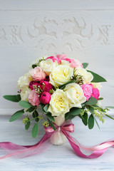 Beauty of colored flowers. Bridal accessories. Close-up bunch of florets. Details for marriage and for married couple. Wedding bouquet with peonies, roses on the white background