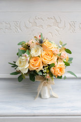 Beauty of yellow flowers. Bridal accessories. Close-up bunch of florets. Details for marriage and for married couple. Wedding bouquet with yellow roses and ribbons