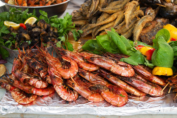 Grilled fish, shrimp, mussels and seafood, lemon and basil. Street food
