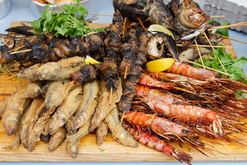 Grilled fish, shrimp, mussels and seafood sticks. Street food
