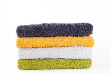 Four colorful towels on white background
