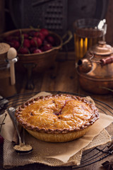 Cherry pie on rustic background