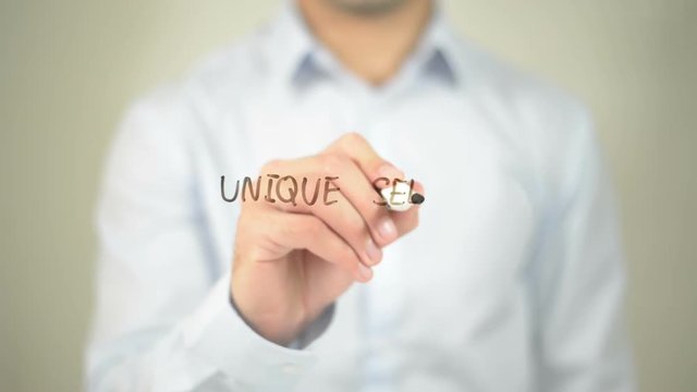 Unique Selling Point , man writing on transparent screen
