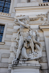 Fototapeta na wymiar Hercules statue near entrance of Hofburg palace. Vienna, Austria