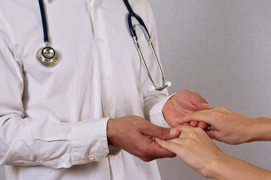 Doctor holding patient hands and comforting her