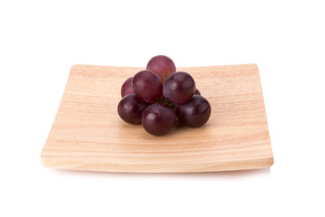 Ripe red grape with leaves isolated on white