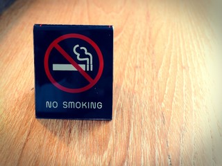 No smoking sign on wooden table in the hotel