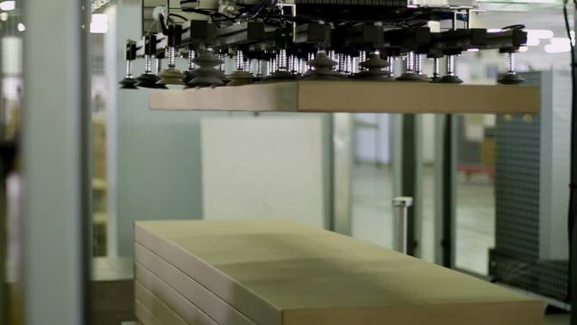 Furniture manufacturing. Furniture parts are packaged on an automated packaging line