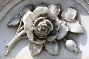 Rose aus weißem Marmor an einem Denkmal