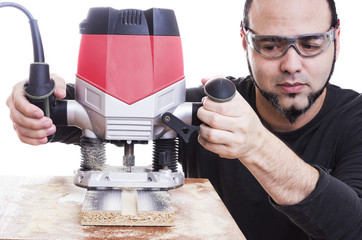 Man using a Plunge router, making a groove on wood