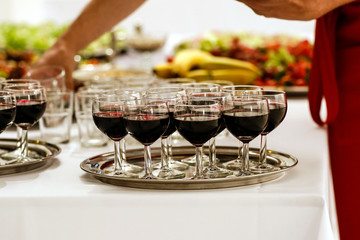Glasses of red wine on the tray 